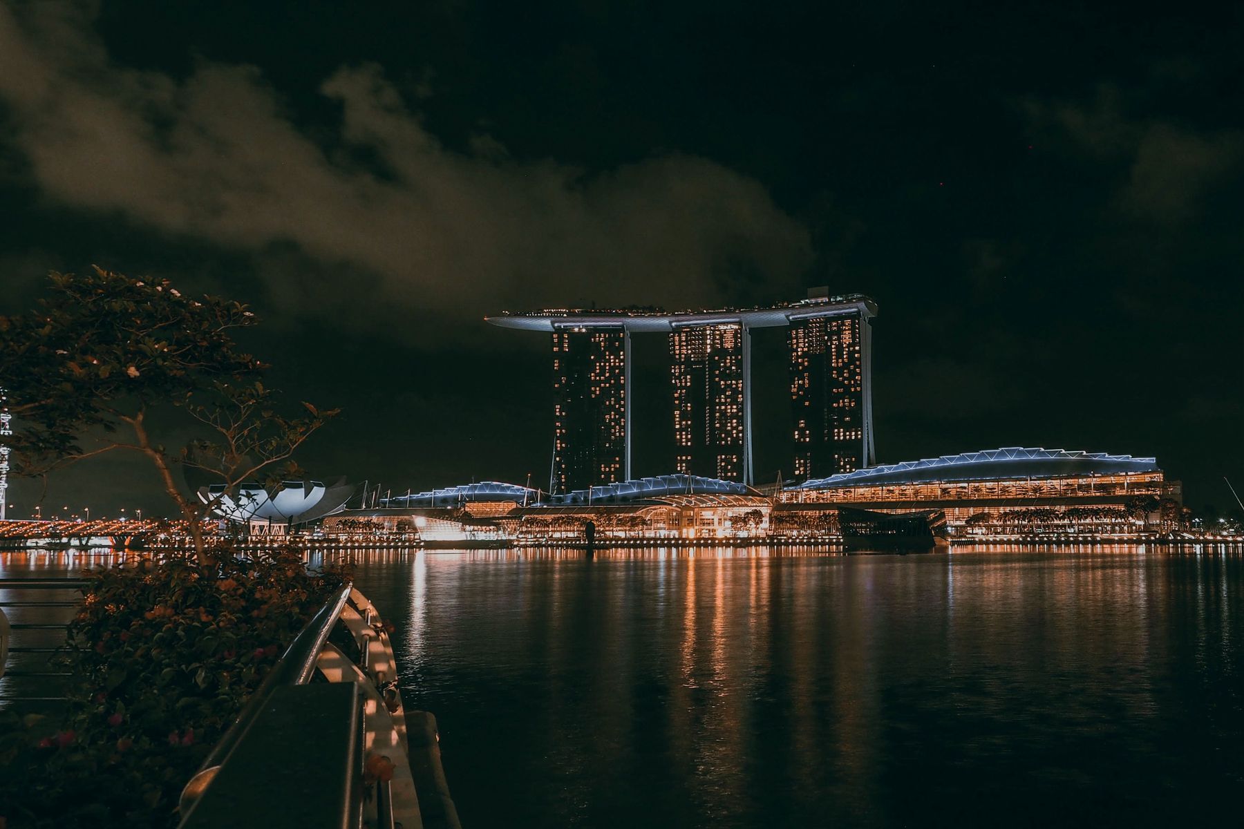 Marina Bay Sands lit up at night across the bay