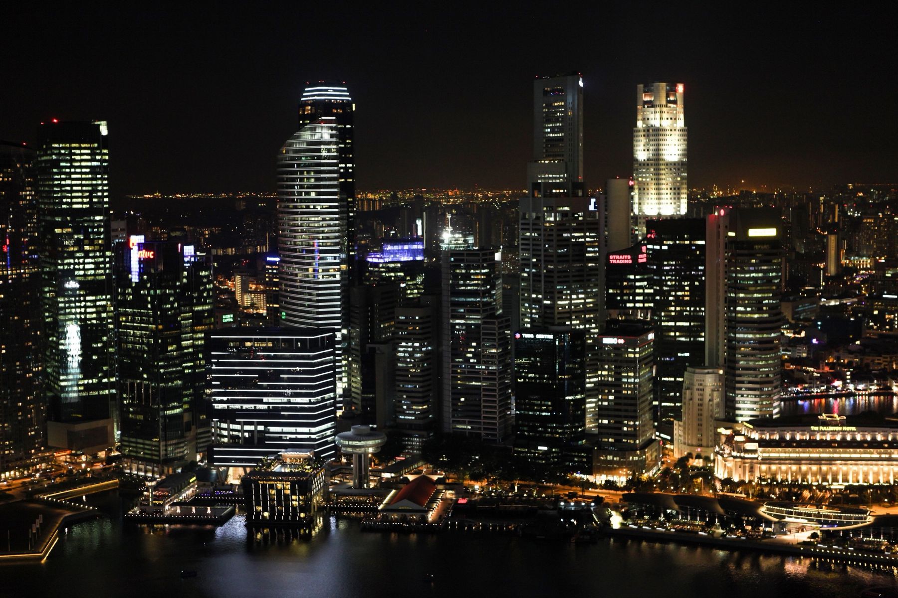 Singapore's city centre and the Fullerton Hotel lit up at night, seen from above