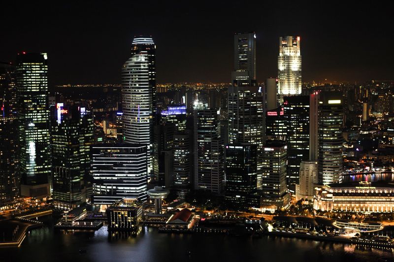 Singapore's city centre and the Fullerton Hotel lit up at night, seen from above
