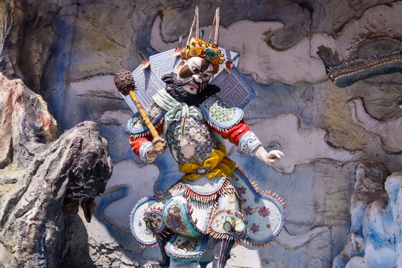 Vibrant traditional Chinese warrior statue at a Singaporean park, rich in cultural detail.