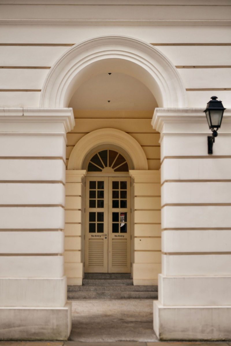 An elegant archway and door of an Asian museum building in Singapore, showcasing classic architecture.