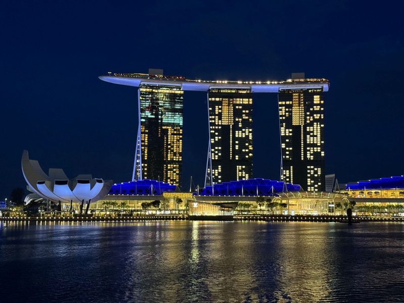 Beautiful night view of the iconic Marina Bay Sands and ArtScience Museum in Singapore, reflecting on the bay.