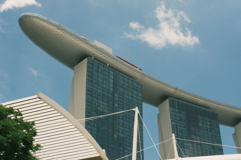 View of the distinctive Marina Bay Sands Hotel in Singapore under a clear blue sky.