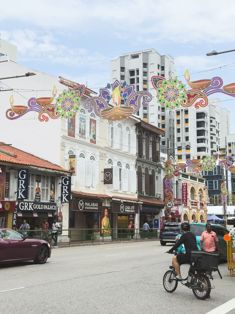A vibrant street in Singapore adorned with festive decorations during daylight, showcasing cultural diversity.