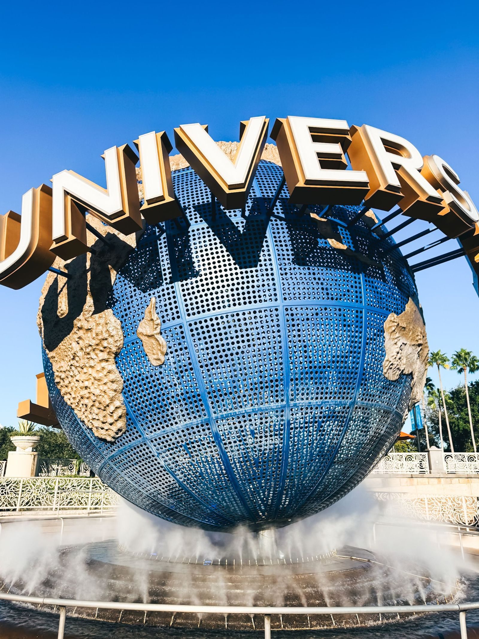 The famous Universal Studios globe fountain with clear blue sky background.