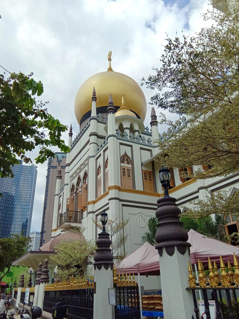 Sultan Mosque's iconic golden dome amid Singapore's skyline, showcasing its architectural beauty.