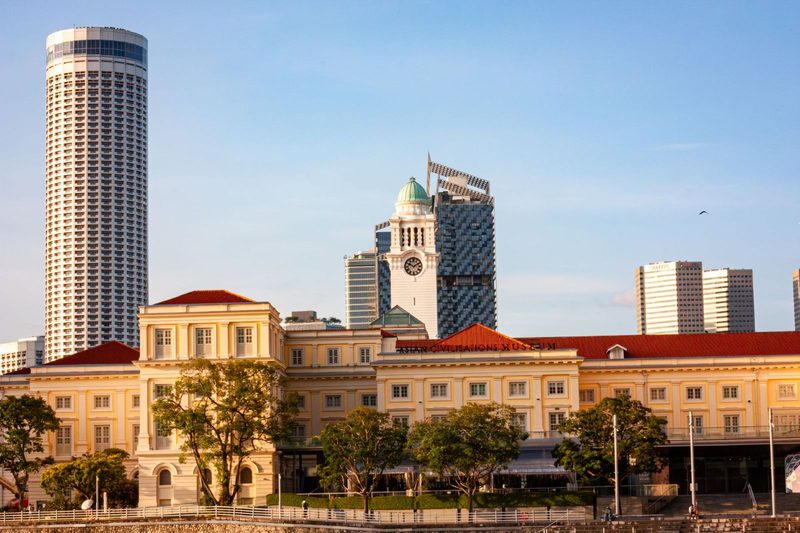 Skyline of Singapore with a blend of modern and colonial architecture, capturing iconic landmarks at sunset.