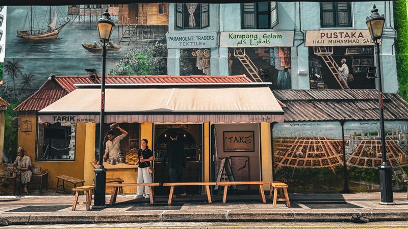 Colorful mural and street scene at Kampong Gelam in Singapore featuring local shops