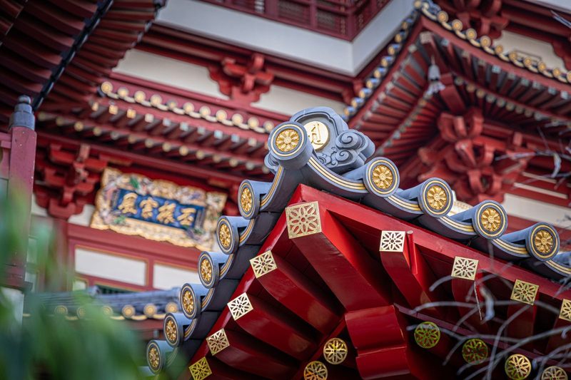 Close-up of traditional architectural elements of a Buddhist temple in Singapore. Captures cultural elegance.