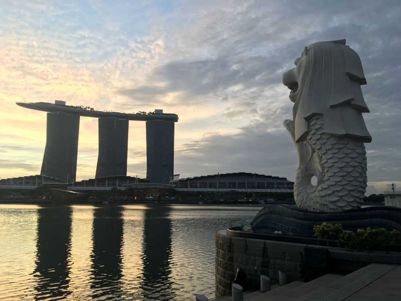 Iconic view of the Merlion and Marina Bay Sands in Singapore at sunrise.