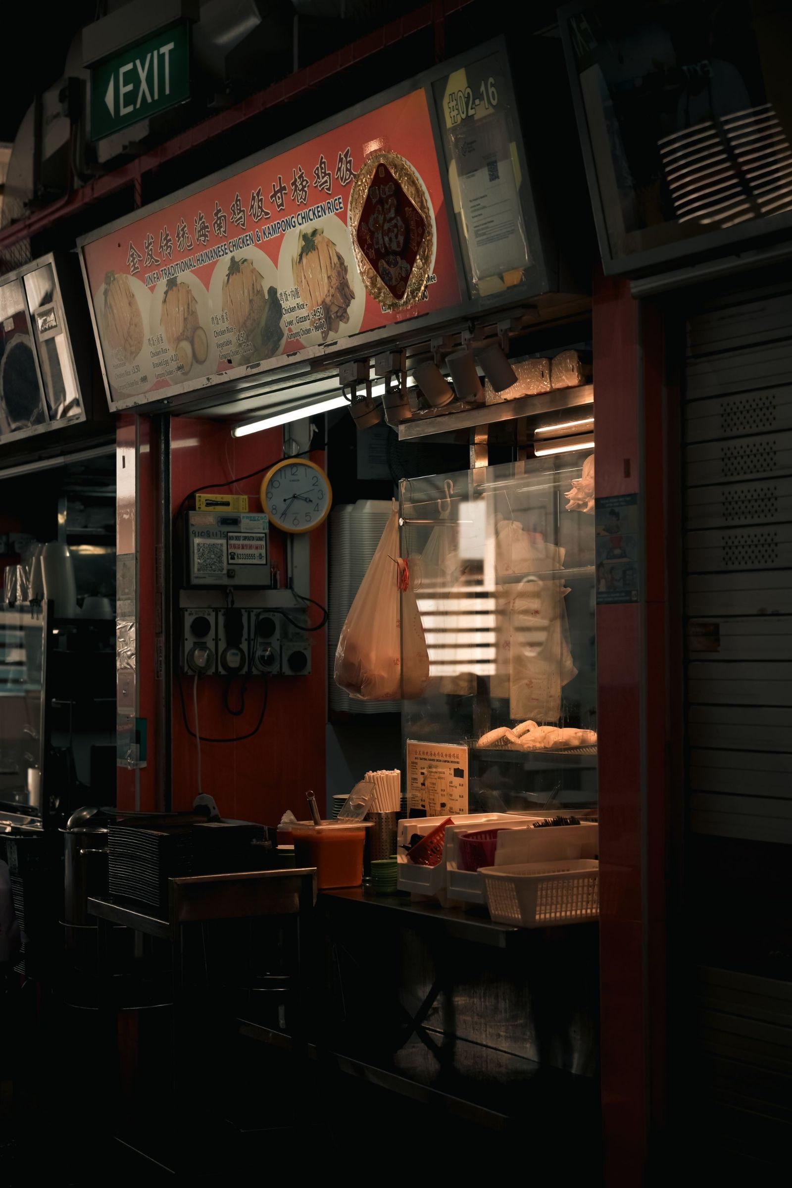 A dimly lit, authentic street food stall in Singapore, showcasing local culinary culture.
