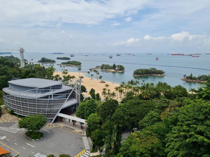 A scenic aerial view of Sentosa Island, showcasing beaches and lush greenery.