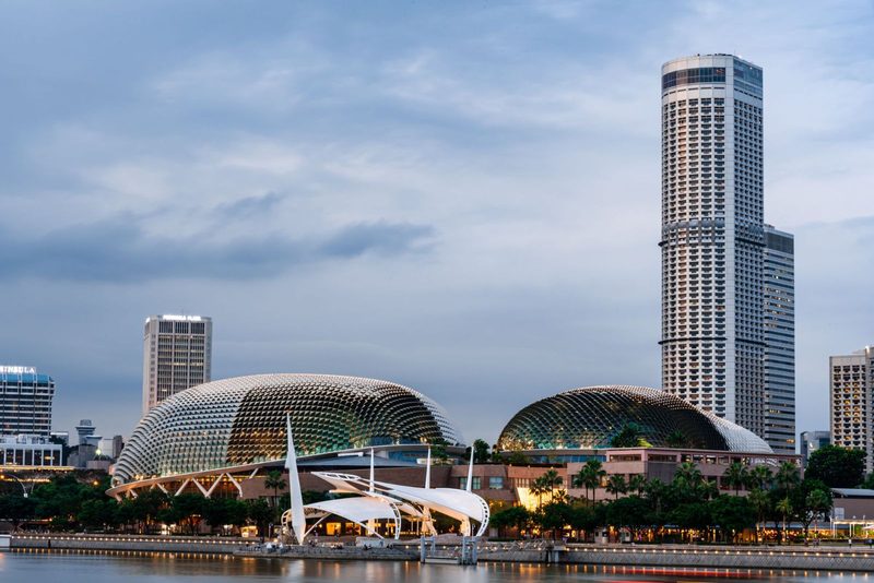 A captivating view of Singapore's skyline, featuring the iconic Esplanade and towering high rises along the waterfront.
