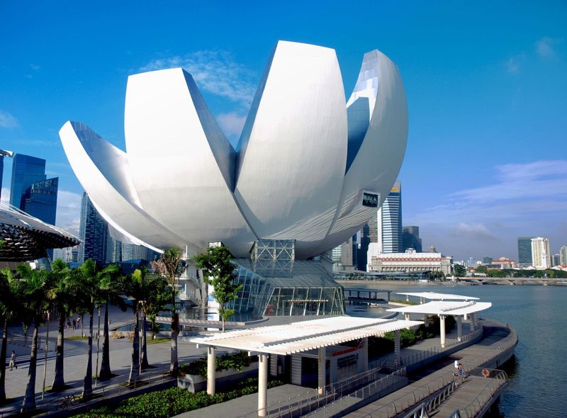 Stunning view of the iconic ArtScience Museum at Marina Bay in Singapore, under a clear blue sky.